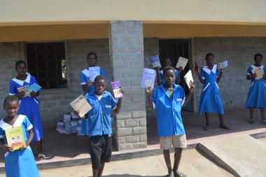 Thangazi One Primary School learners with some of the textbooks donated by ActionAid Malawi and Kuchene Women Forum