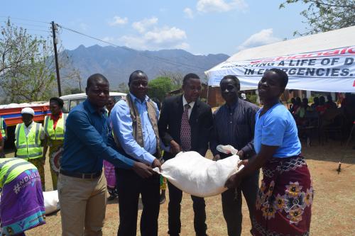 Assan Golowa (2nd Left) symbolically handing over the relief items to ECD centres in Phalombe