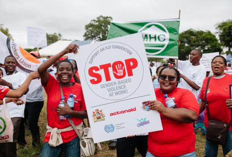 Young women mobilised by AAM carrying a placard during the labour day commemoration in Blantyre.