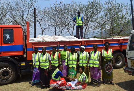 Ready for distribution: Phalombe Women Forum members posing with the truck carrying relief items