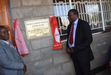 Golowa (Right) and Council Rep, Regson Nkolongo unveiling the plaque to mark the official handover of the school