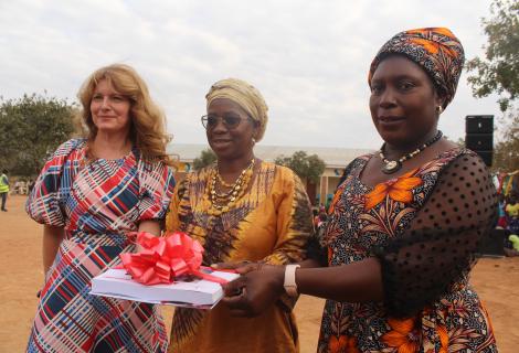 7. Haedel, left presenting a CBCC catalogue to Mamhumula flanked by ActionAid Malawi Board Chairperson, right , Professor Dorothy Nampota