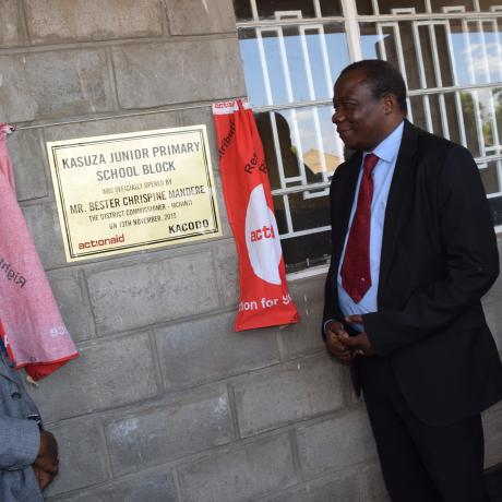 Golowa (Right) and Council Rep, Regson Nkolongo unveiling the plaque to mark the official handover of the school
