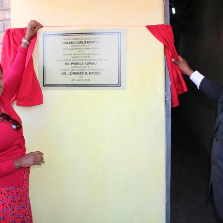 Kuwali (left) and Kayira unveiling a plaque to officially open the hostel