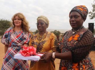 7. Haedel, left presenting a CBCC catalogue to Mamhumula flanked by ActionAid Malawi Board Chairperson, right , Professor Dorothy Nampota