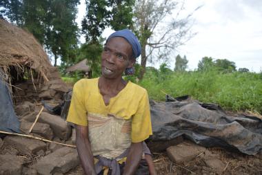 Esther Kachingwe sitting in front of what used to be her house